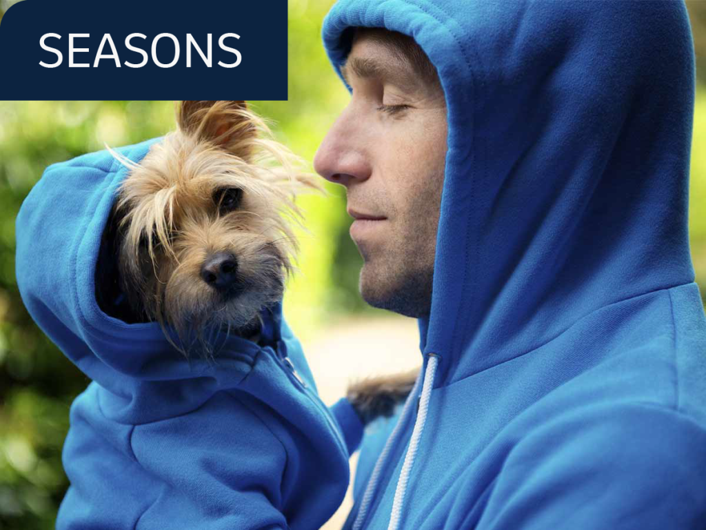 Man and his dog wearing the same hoodie.